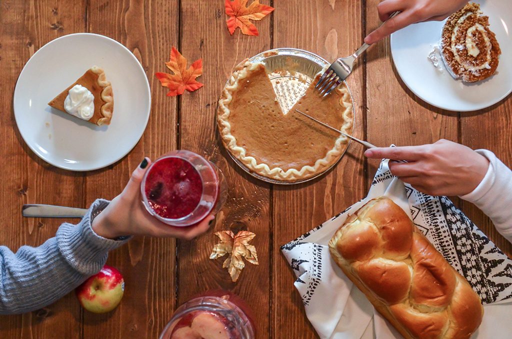 A family eating pumpkin pie for dessert on Thanksgiving.