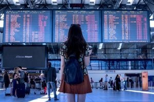Photo of a girl at the airport, contemplating what to eat.
