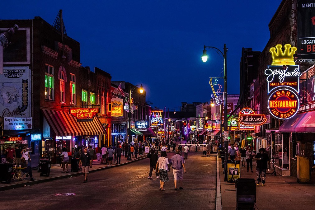 Beale Street lit up with bars and clubs at night in Memphis.
