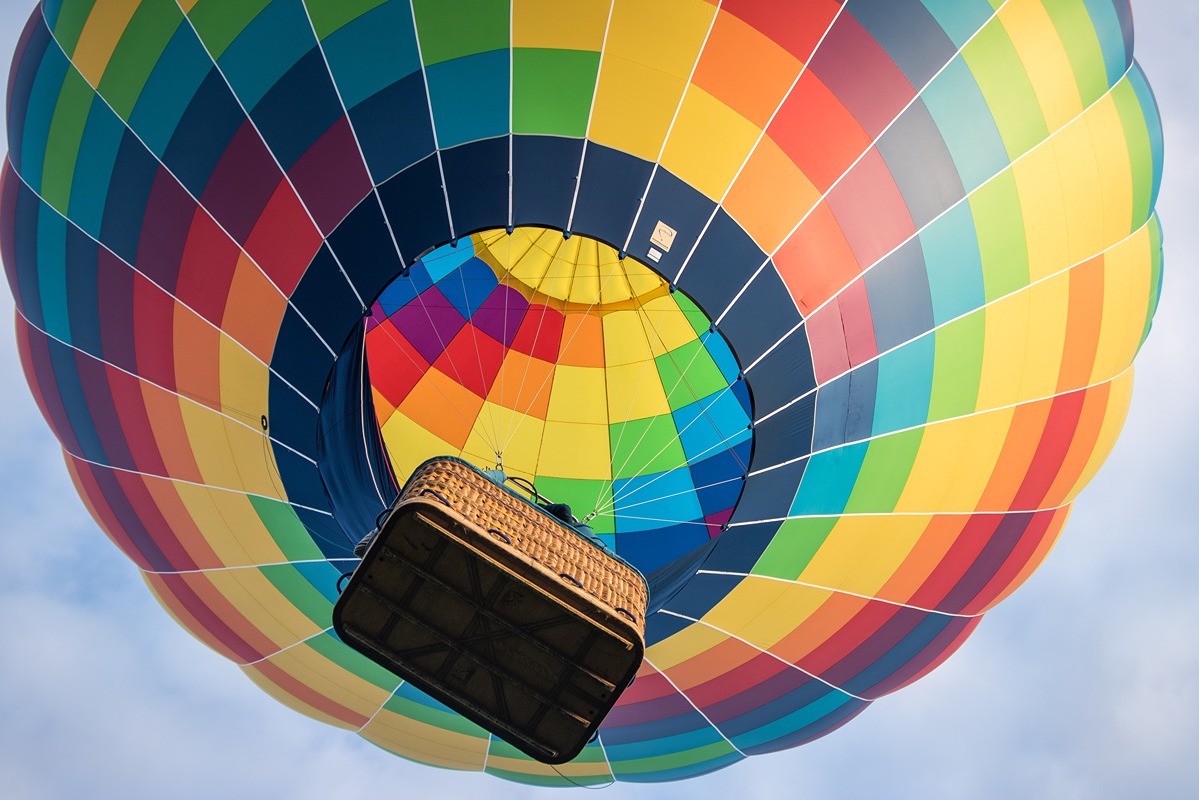 Photo of hot air balloon taken from below with a glimpse inside the balloon