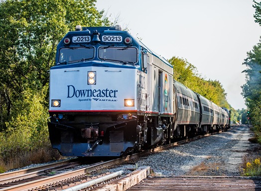 Front view of an Amtrak Downeaster train on railroad tracks