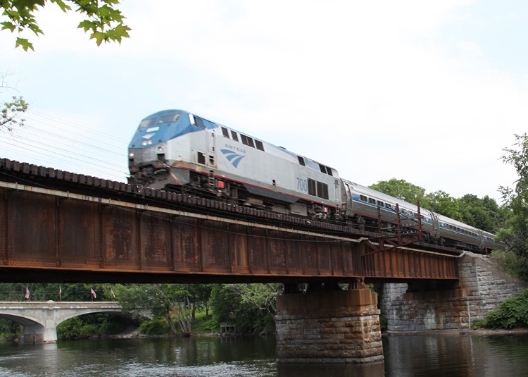 An Ethan Allen Express train crosses a rail bridge