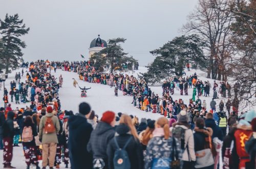 A crowd watches a fun sledding race